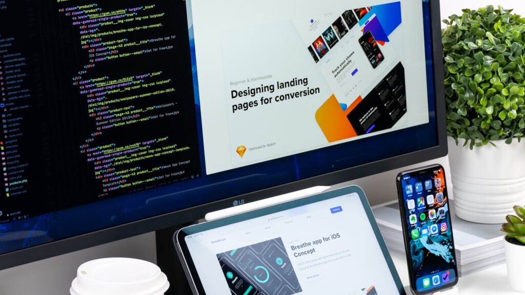 Web design workspace with landing page mockups on screen — Overworld website revamp with AdCendes